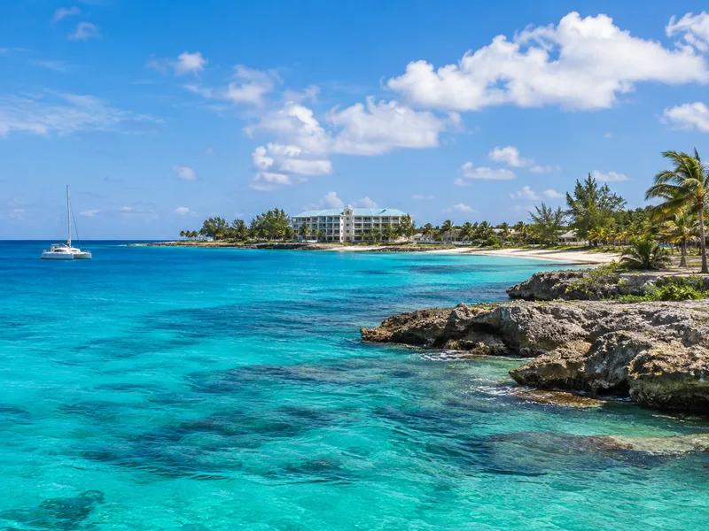 Illustrative Cayman tropical coastline; not company premises